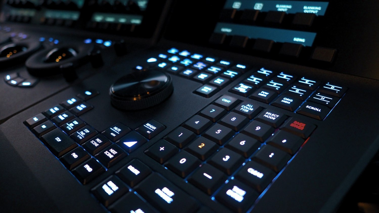 Illuminated video production control panel with screens and buttons